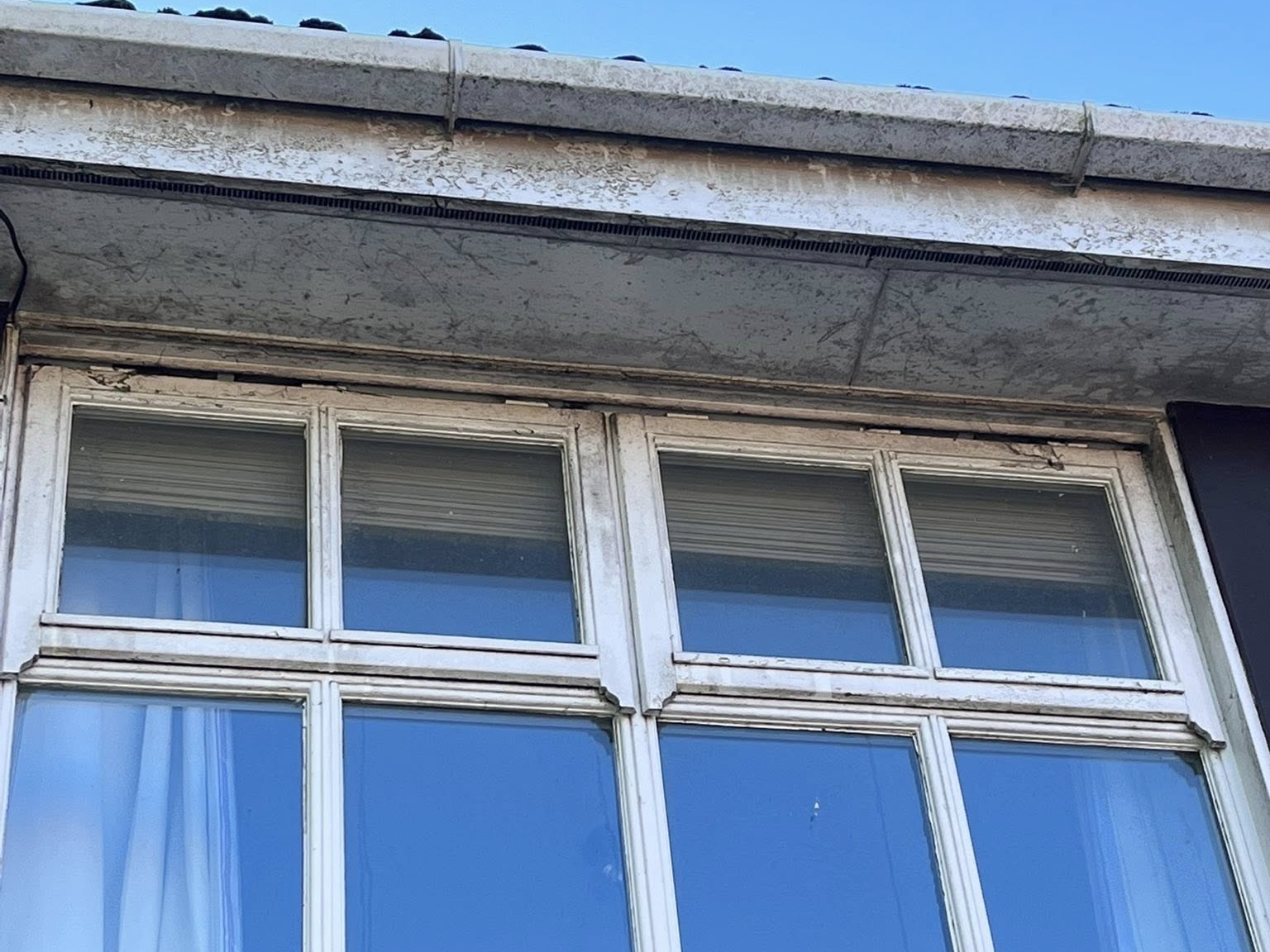 Office block windows before cleaning — grimy and streaked